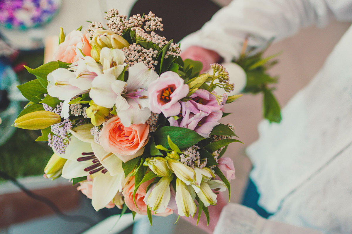 A young florist enjoying on arranging bouquets for clients