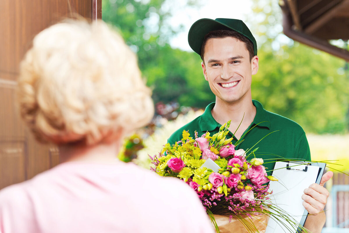 Old woman receives flower delivery