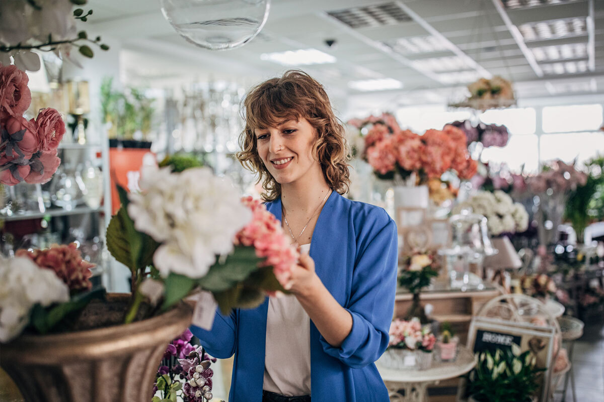 Young female florist working in flower shop