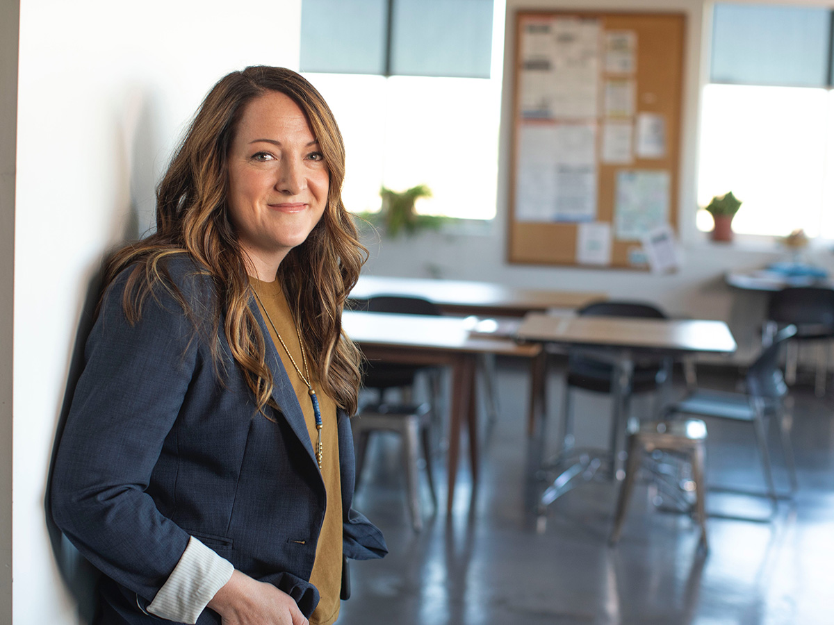 A teacher standing outside her classroom.