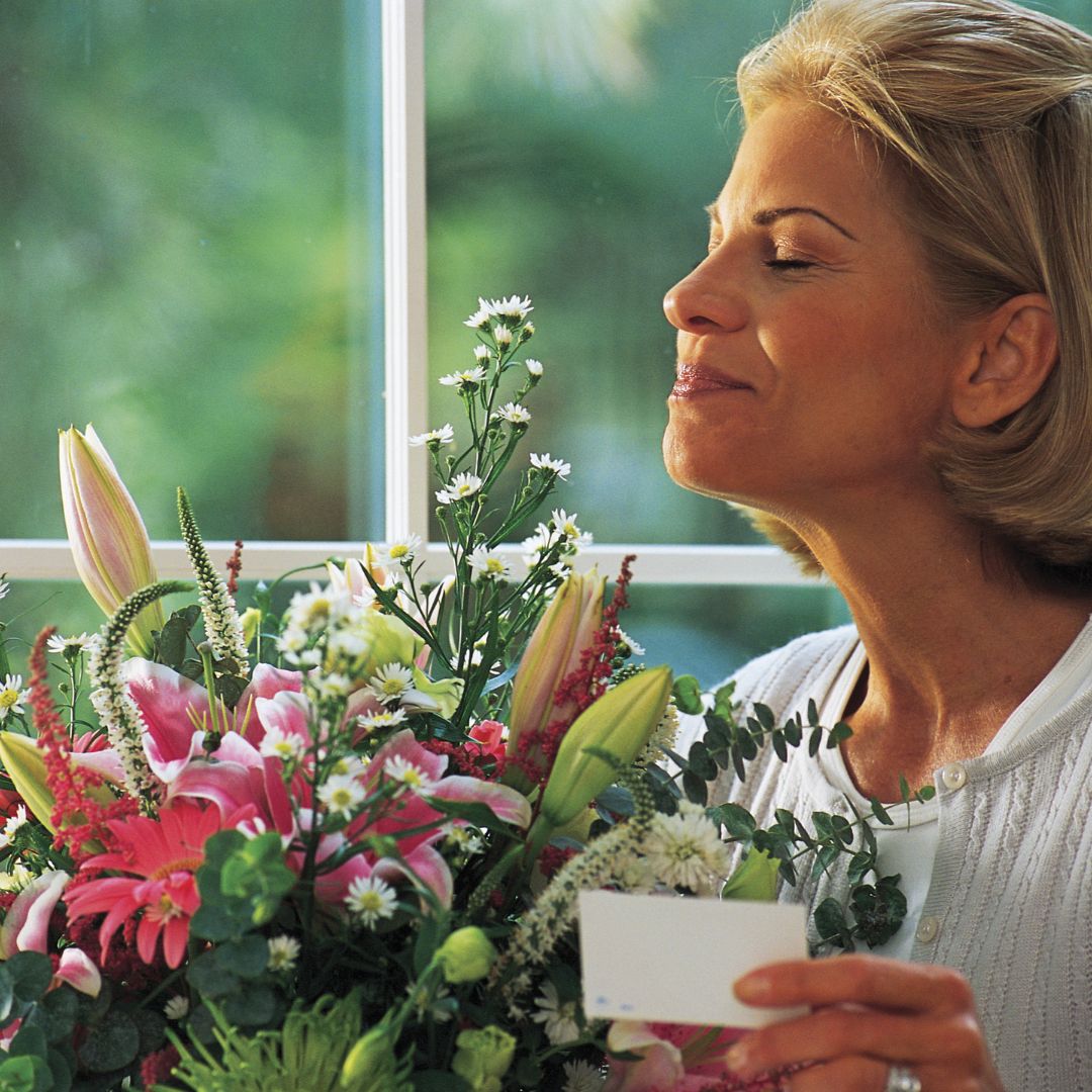 woman smelling flowers