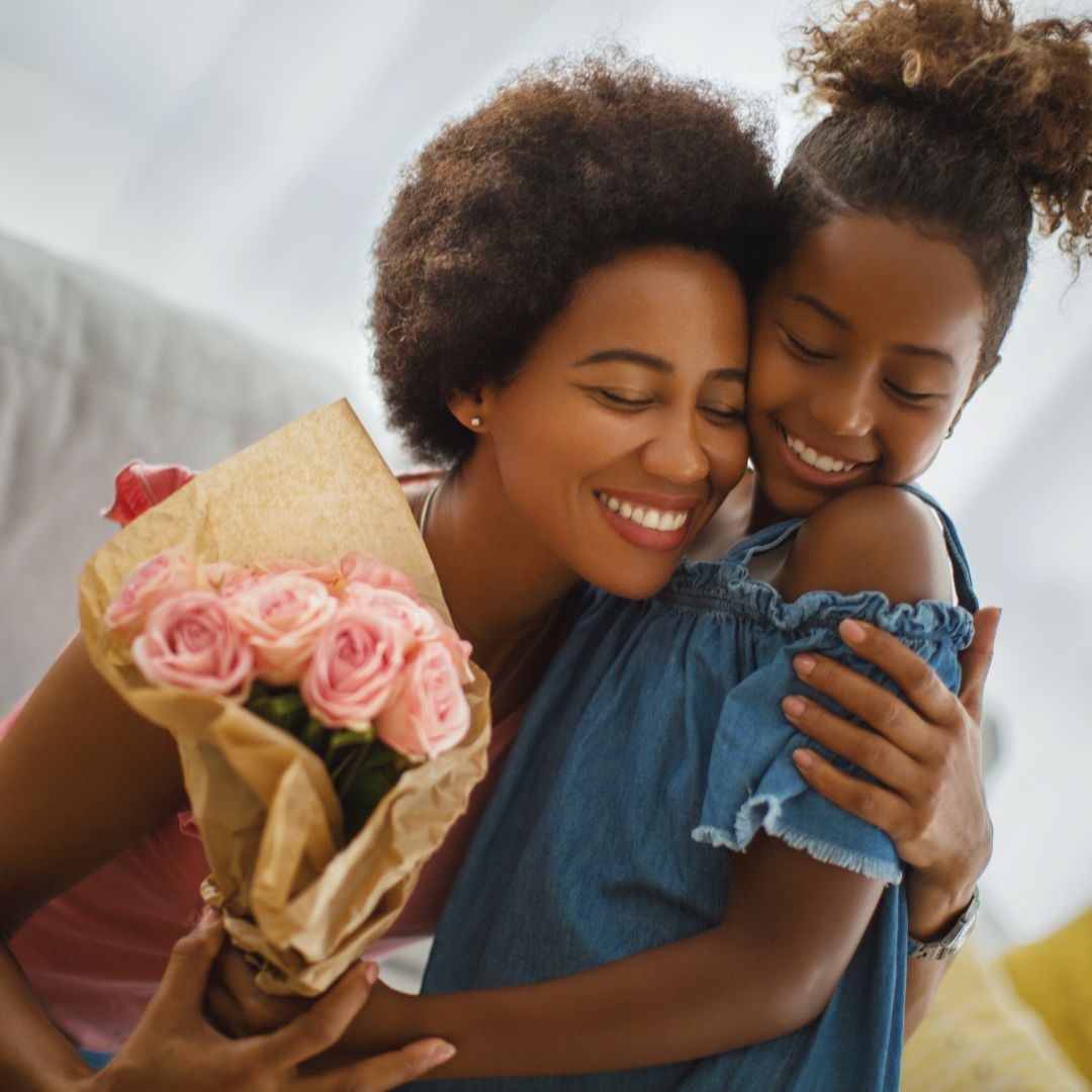 Young child giving mom a bouquet of flowers